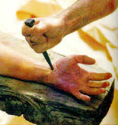 Jesus' hand being nailed